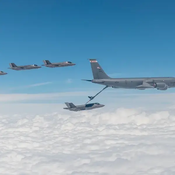 F-35s fly, with one refuelling