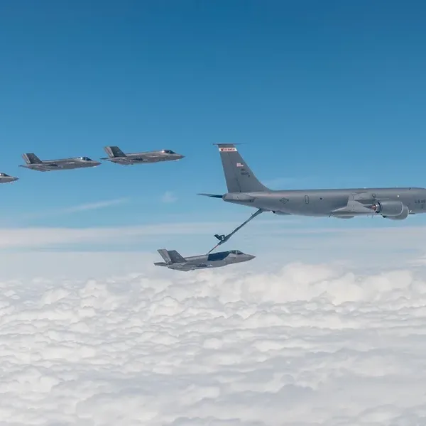 F-35s fly, with one refuelling