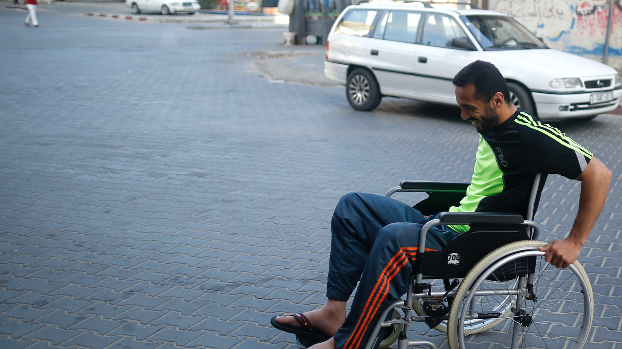 Fadi Deeb smiles in a wheelchair