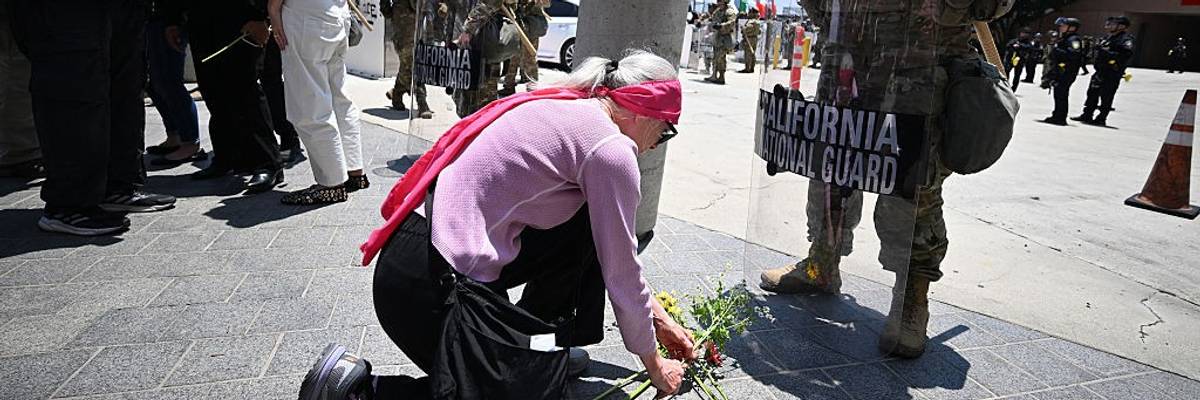 Faith leader lays flowers at feet of National Guard in LA