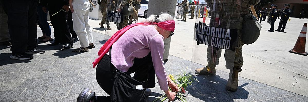 Faith leader lays flowers at feet of National Guard in LA