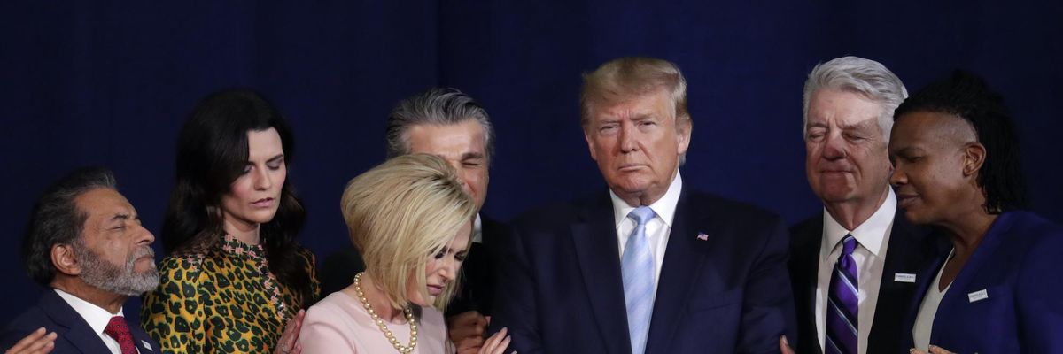 Faith leaders pray with President Donald Trump during a Jan. 3, 2020 rally for evangelical supporters at the King Jesus International Ministry church in Miami. (Photo: Lynne Sladky / AP)