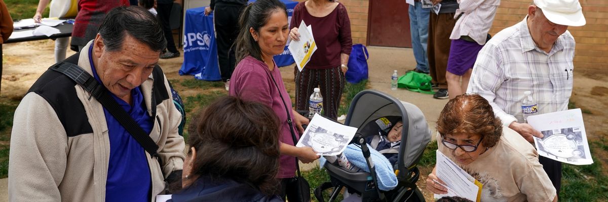 Families gather for resources, including Medicaid eligibility and enrollment information offered by Neighborhood Health