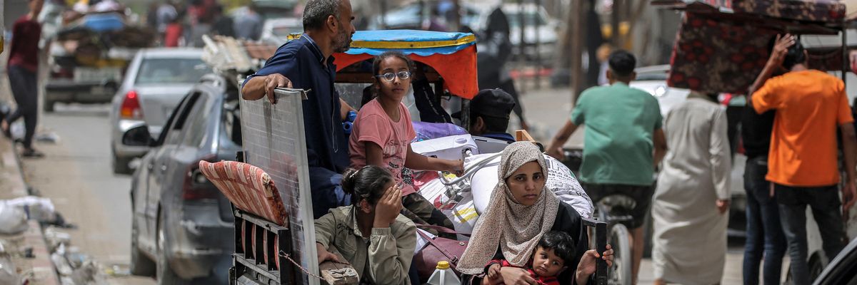 Family evacuates Rafah in tricycle.