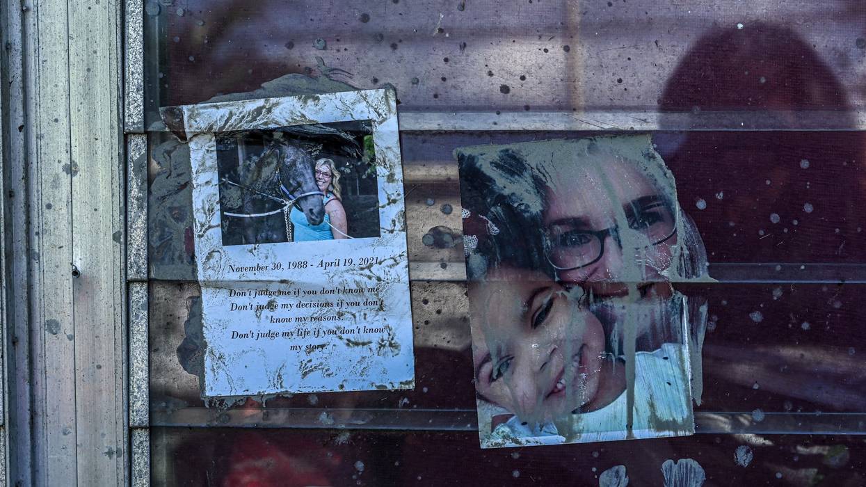Family photos are seen taped to a window at a home in the aftermath of Hurricane Ian in San Carlos Island, Florida on October 1, 2022.