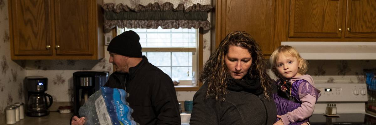 Family stands in kitchen