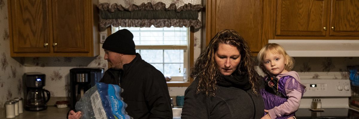 Family stands in kitchen