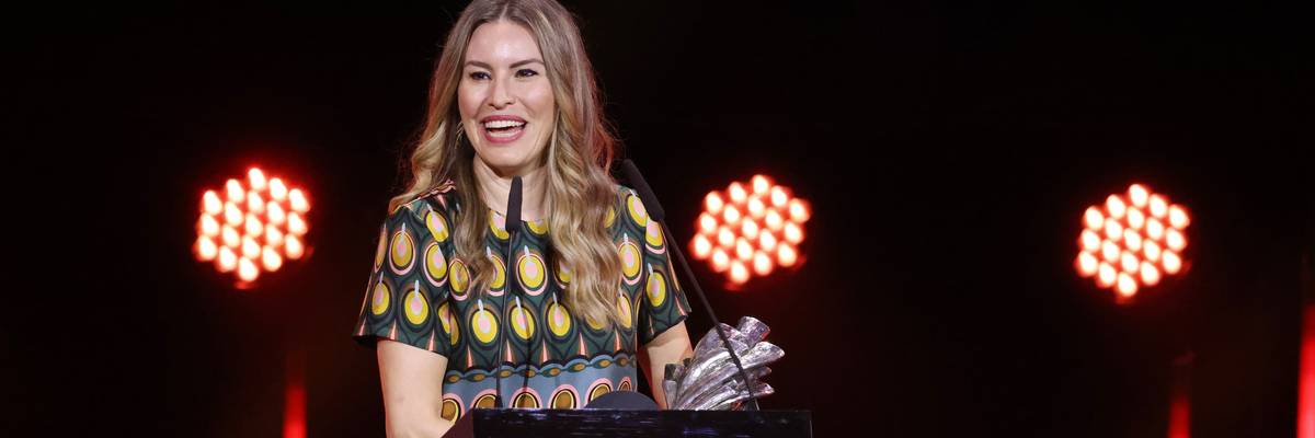 Farah Nabulsi speaks while holding award.