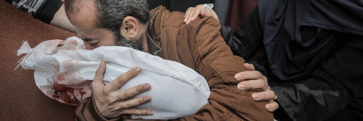 Father Jamil Al-Agha cradles his 5-year-old son killed in airstrikes