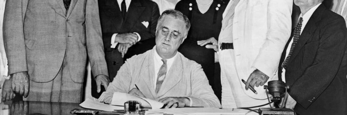 FDR signs the Social Security Act.