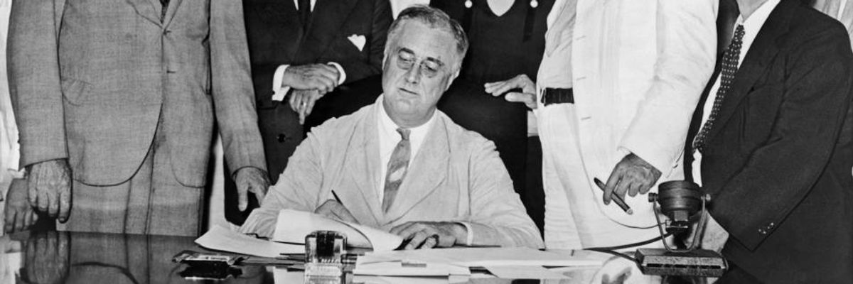FDR signs the Social Security Act.