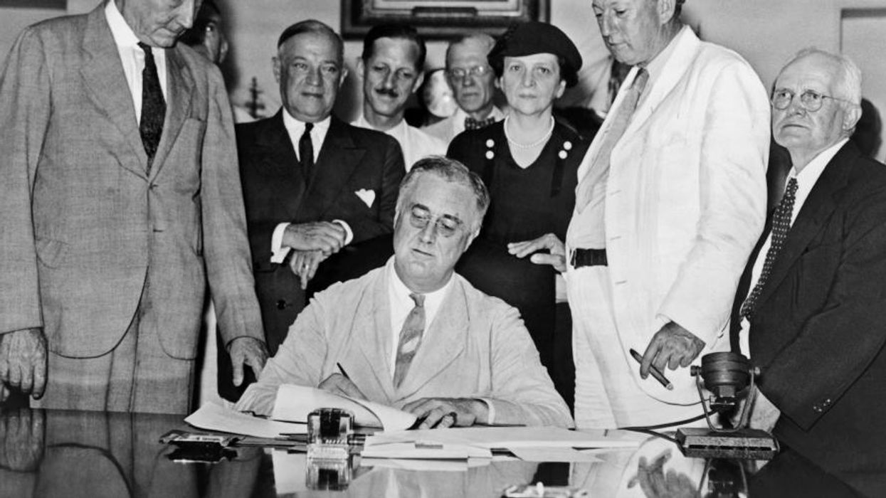 FDR signs the Social Security Act.