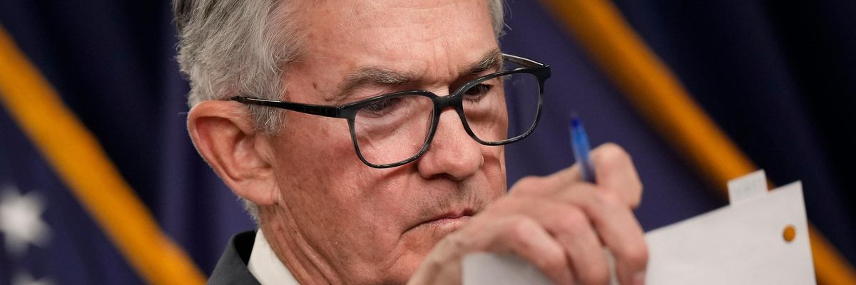 Fed Chair Jerome Powell looks at notes during a press conference
