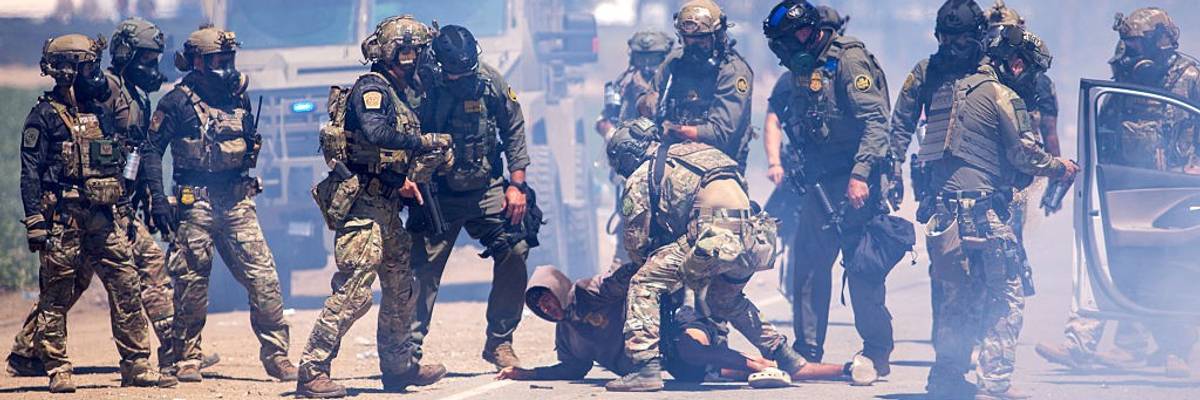 Federal agents arrest a person during a raid on a California farm