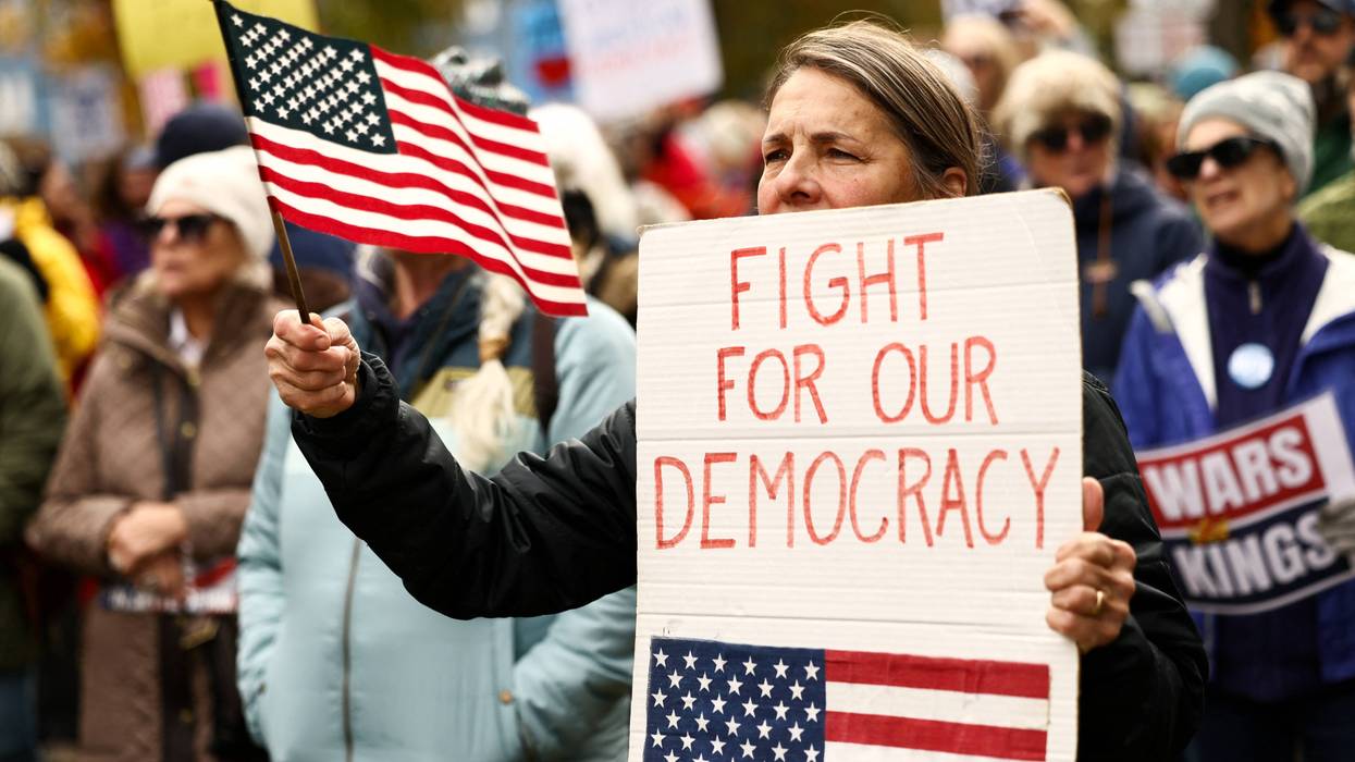 "Fight for Our Democracy" sign reads at No Kings protest in 2026
