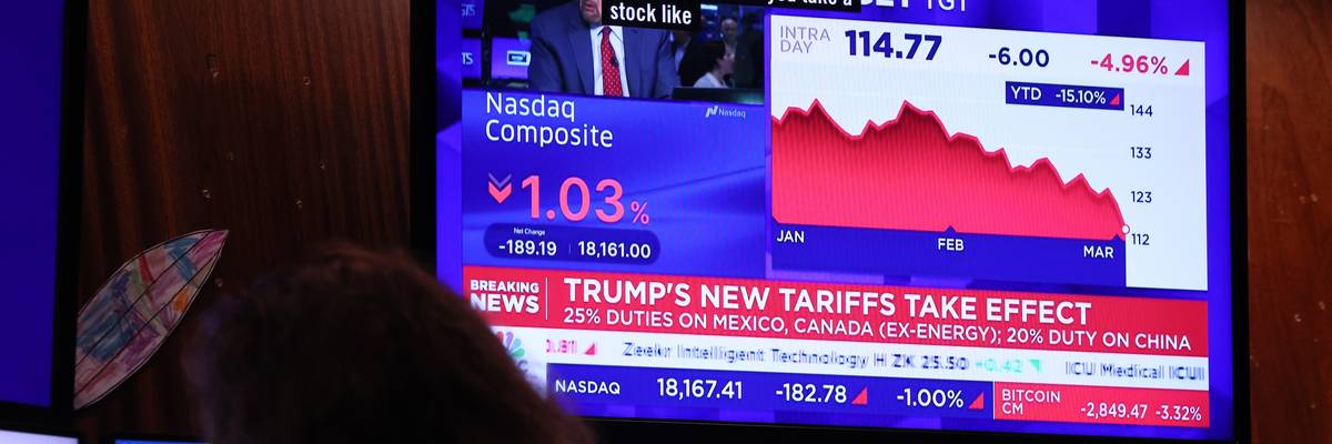 Financial news is seen on a television on the floor of the New York Stock Exchange
