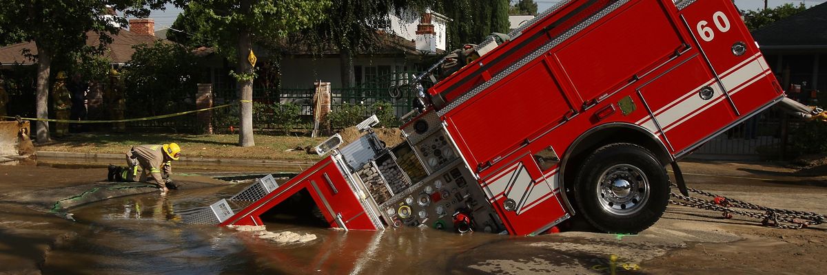 Fire Truck Trapped In Giant Sinkhole