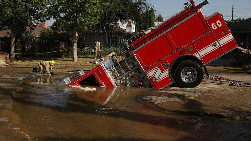 Fire Truck Trapped In Giant Sinkhole