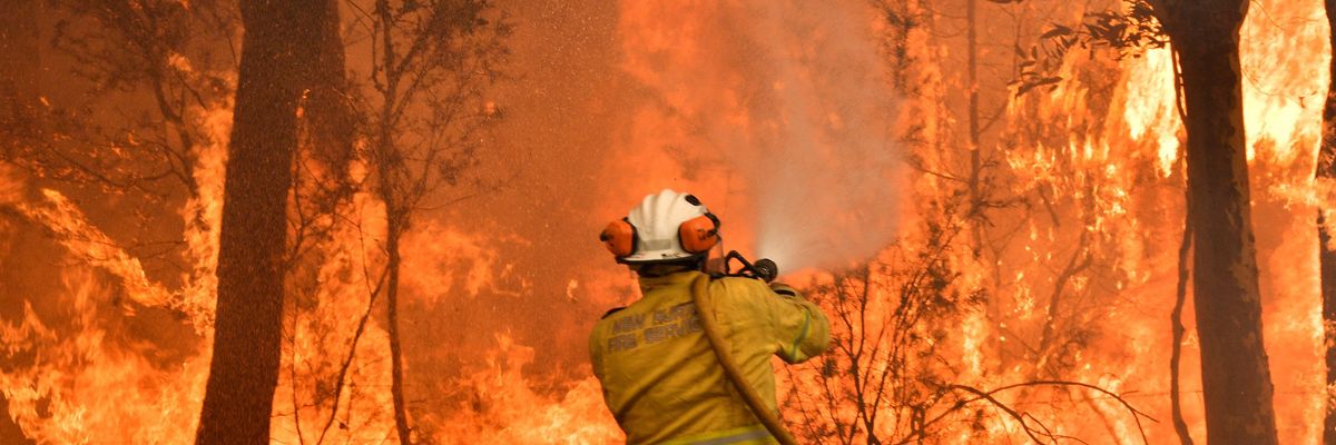 Firefighter battling bushfires about 100 km north of Sydney