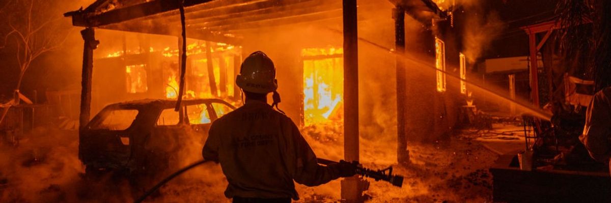 Firefighter before burning house in Altadena