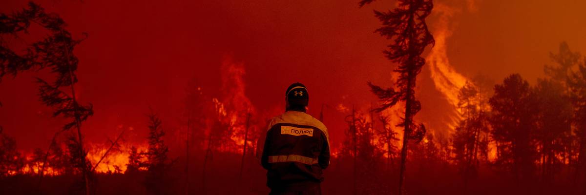 Firefighters attempt to extinguish a wildfire in the village of Kuel in Yakutia, Sakha, Russia on August 8, 2021