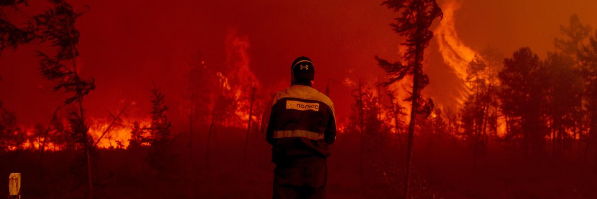 Firefighters attempt to extinguish a wildfire in the village of Kuel in Yakutia, Sakha, Russia on August 8, 2021