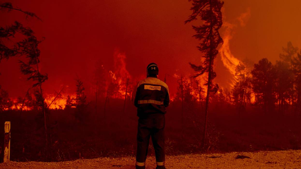 Firefighters attempt to extinguish a wildfire in the village of Kuel in Yakutia, Sakha, Russia on August 8, 2021