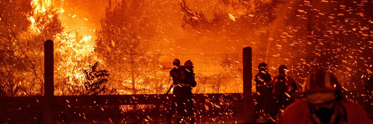 Firefighters combat a wildfire in Athens, Greece