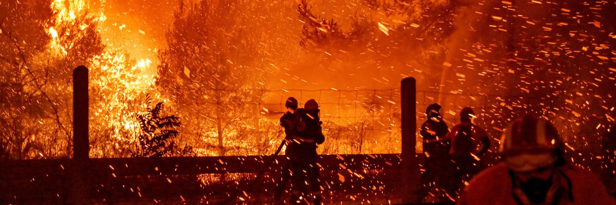 Firefighters combat a wildfire in Athens, Greece
