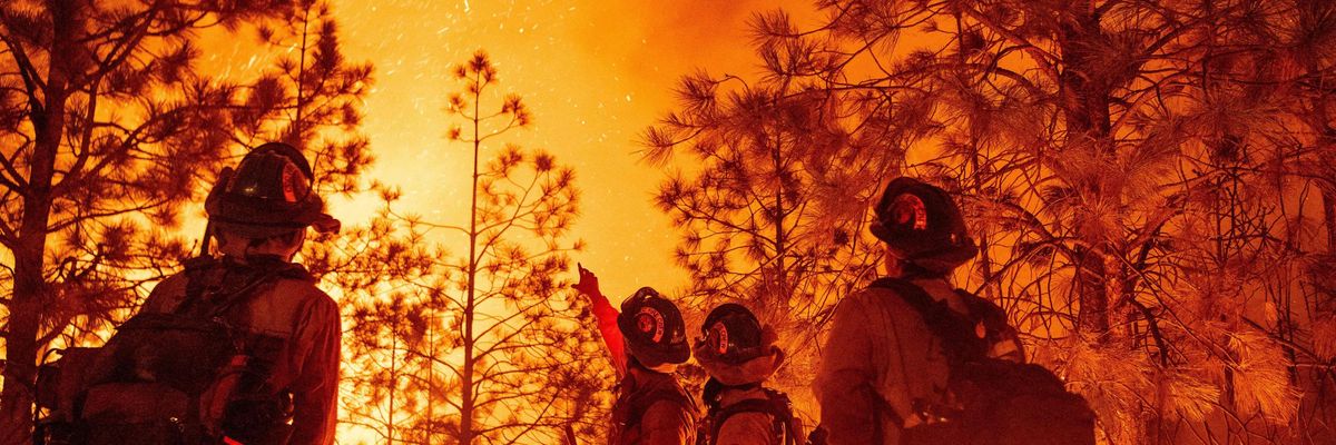 Firefighters monitor a wildfire