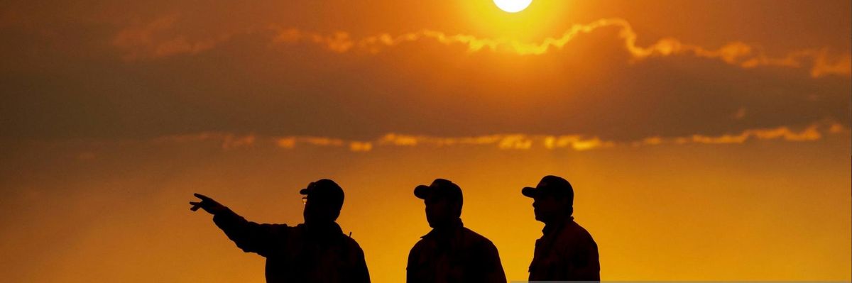 Firefighters monitor the scene as the Lava fire continues to burn in Weed, California on July 1, 2021. - Firefighters are battling nearly a dozen wildfires in the region following soaring temperatures in California's valley, mountain and desert areas, windy dry conditions, lightning storms across several parts of the western United States.