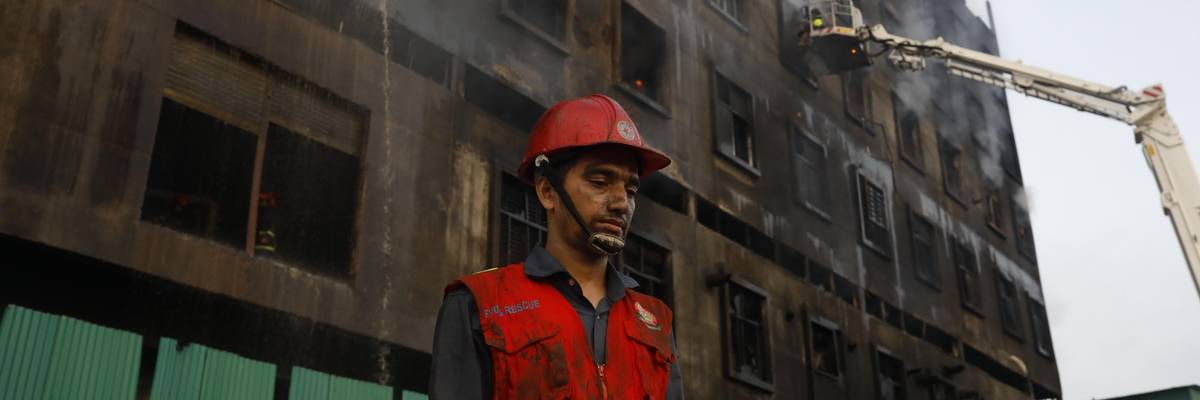 Firefighters try to extinguish flames that broke out in a beverage and food factory in Narayanganj, Bangladesh on July 9, 2021. (Photo: Stringer/Anadolu Agency via Getty Images)