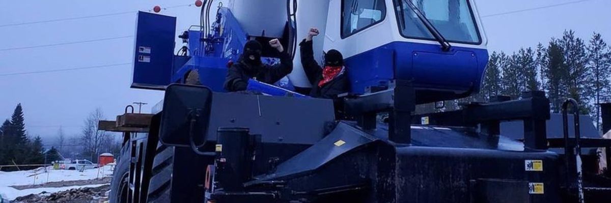 First Nations land defenders lock themselves to equipment at a Trans Mountain Corporation pumping station