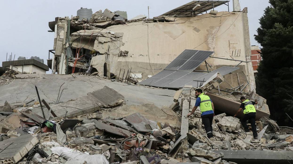 First responders inspect the site of an Israeli airstrike in the southern Lebanese village of Abbasiyeh