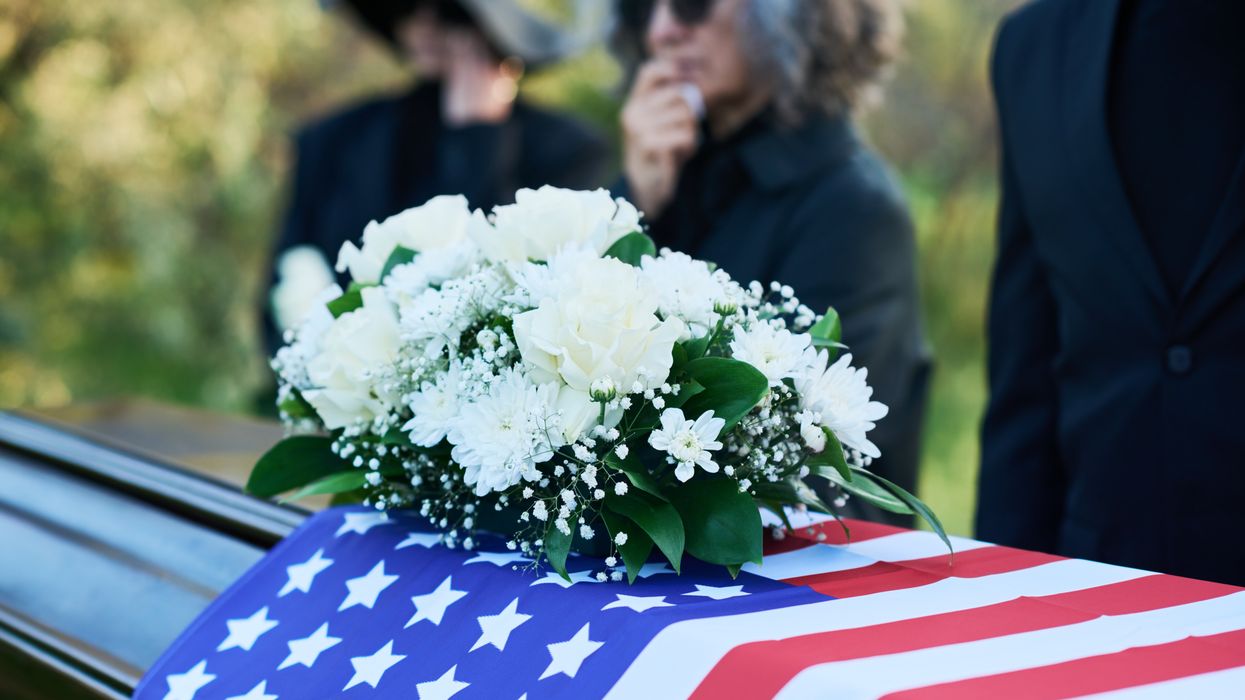 Flag-draped coffin.