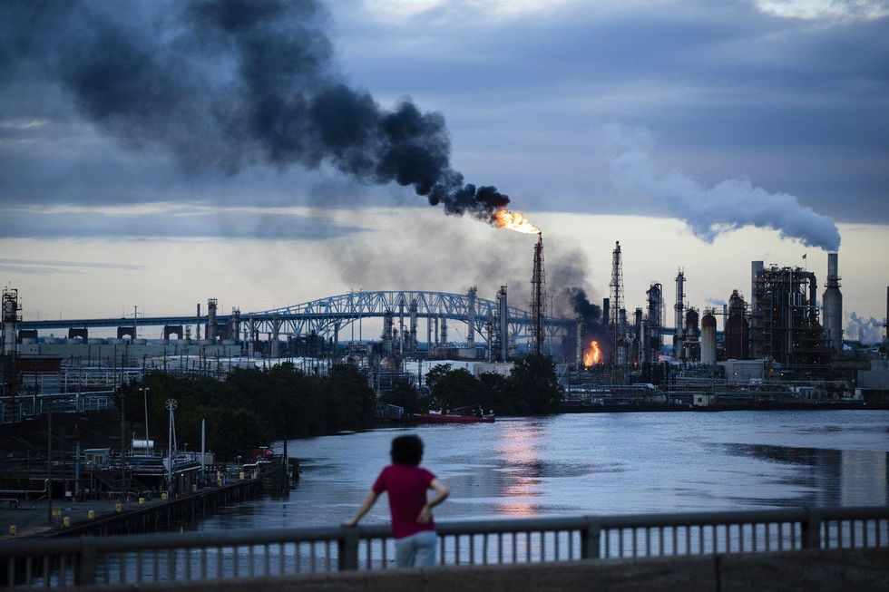 Flames and smoke emerge from the Philadelphia Energy Solutions Refining Complex in Philadelphia, Friday, June 21, 2019. Explosions and a blaze at the largest oil refinery on the East Coast shook homes before dawn Friday, though authorities reported only a few minor injuries and said the air was safe to breathe. (AP Photo/Matt Rourke)