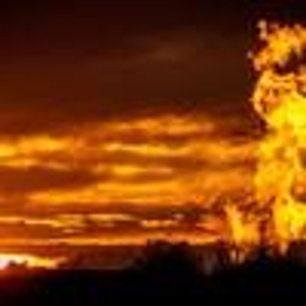 Flames are visible from a flaring pit near a well in the Bakken Oil Field. The primary component of natural gas is methane, which is odorless when it comes directly out of the gas well. (Photo: Orjan F. Ellingvag/Corbis via Getty Images)