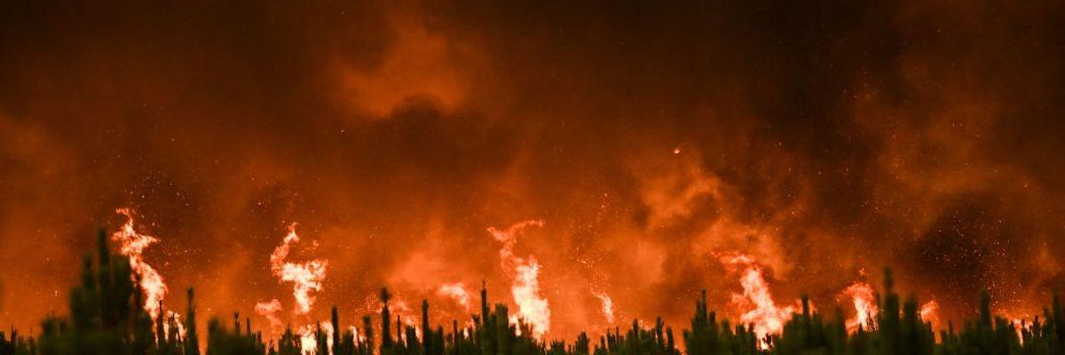 Flames burn trees during a forest fire near Belin-Beliet in Gironde, southwestern France, on August 10, 2022.