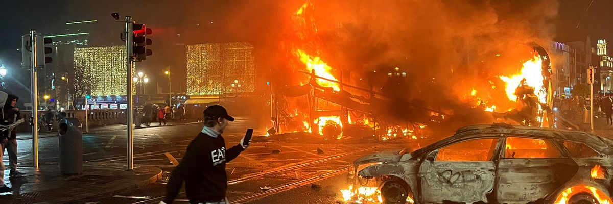 Flames rise from a car and a bus in Dublin