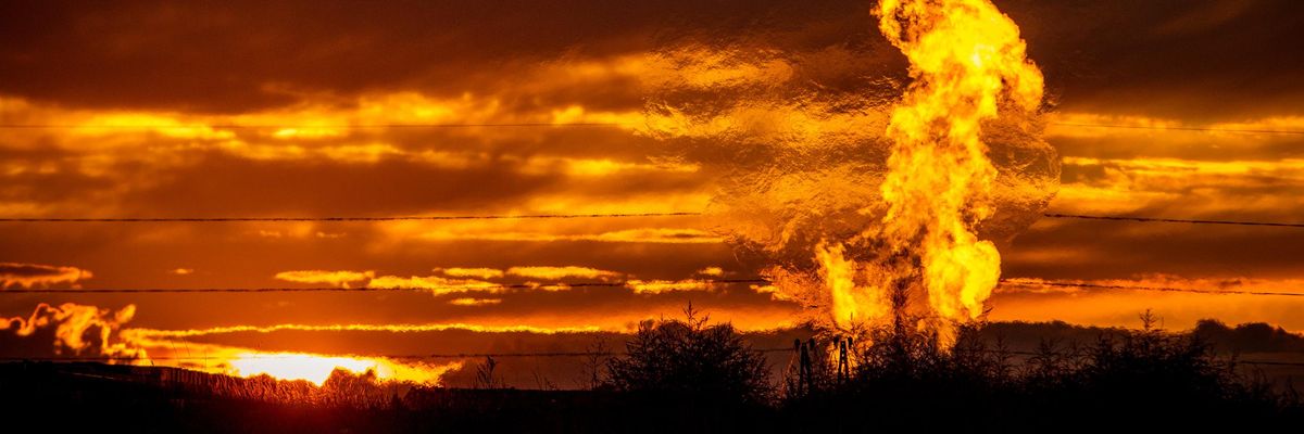 Flames rise from a flaring pit near a well in the Bakken Oil Field. The primary component of natural gas is methane, which is odorless when it comes directly out of the gas well. (Photo: Orjan F. Ellingvag/Corbis via Getty Images)
