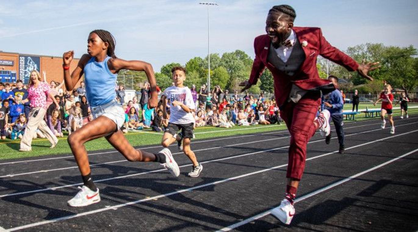 Former Olympic runner and school superintendent Dr. Ian Roberts races some of his kids. 