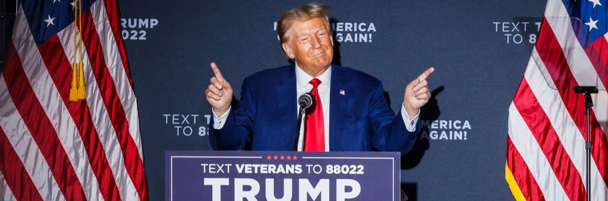 Former President Donald Trump speaks at a podium.