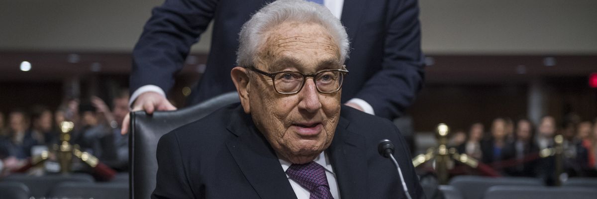 Former Secretary of State Henry Kissinger arrives to testify at a Senate hearing.