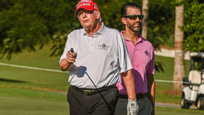 Former U.S. President Donald Trump and his son, Donald Trump Jr., play golf at Trump National Doral Miami golf club on October 27, 2022 in Miami, Florida.