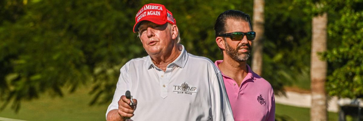 Former U.S. President Donald Trump and his son, Donald Trump Jr., play golf at Trump National Doral Miami golf club on October 27, 2022 in Miami, Florida.
