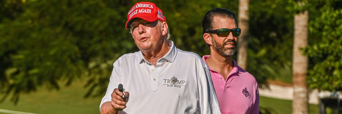 Former U.S. President Donald Trump and his son, Donald Trump Jr., play golf at Trump National Doral Miami golf club on October 27, 2022 in Miami, Florida.