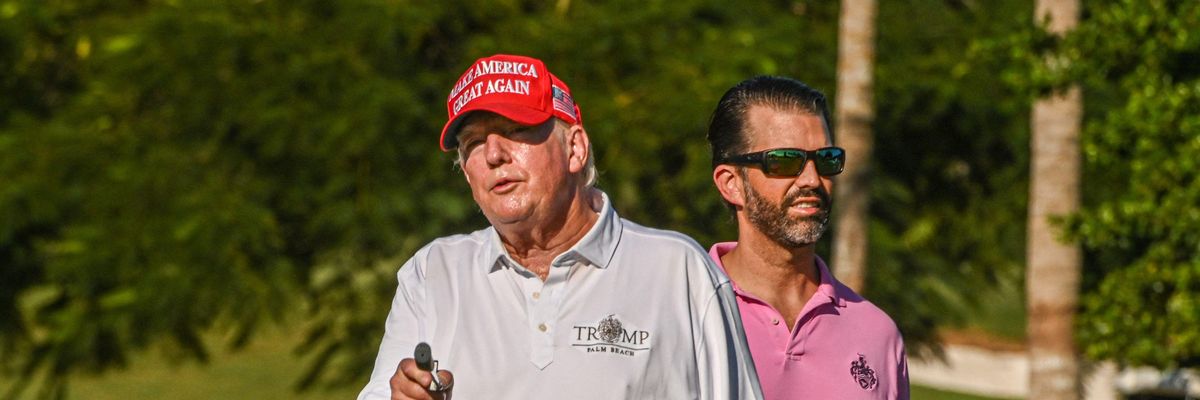 Former U.S. President Donald Trump and his son, Donald Trump Jr., play golf at Trump National Doral Miami golf club on October 27, 2022 in Miami, Florida.