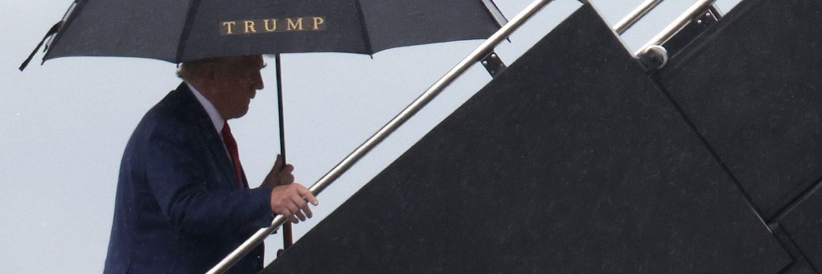 Former U.S. President Donald Trump boards his plane