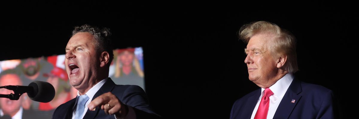 Former U.S. President Donald Trump listens as Wisconsin Republican gubernatorial candidate Tim Michels speaks during a rally on August 5, 2022 in Waukesha, Wisconsin.