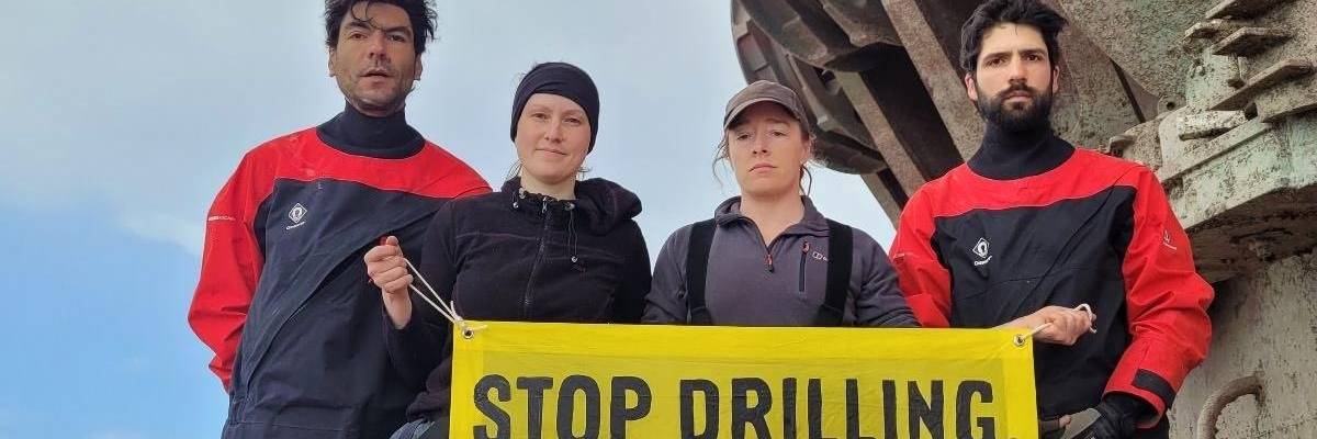 Four Greenpeace activists are pictured on a Shell vessel in the Atlantic Ocean on January 31, 2023.